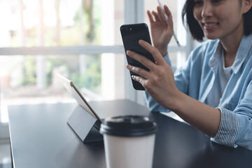 Young asian business woman making facetime video calling using zoom online meeting app working from home office