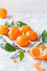 Tangerine, mandarine or clementine on white marble background.