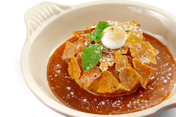 Apple Pie or Tart with caramel, mint crunchy waffles in a bowl on a white background, close up