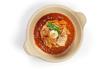 Apple Pie or Tart with caramel, mint crunchy waffles in a bowl on a white background, top view