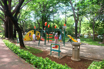 Fototapeta na wymiar Jakarta, Indonesia - 31 October 2020: Kelapa Gading Jogging Park, beautiful trees and children's play facilities in Kelapa Gading, North Jakarta