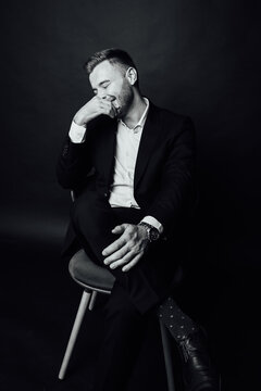 Handsome businessman man sitting on chair in photo studio
