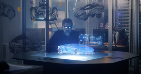 Male engineer using 3D technology to design car