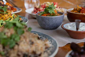 
full table healthy Indian, Asian and Mediterranean dishes with white beans, lentils, sweet potatoes, rice and vegetables