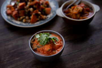 
full table healthy Indian, Asian and Mediterranean dishes with white beans, lentils, sweet potatoes, rice and vegetables