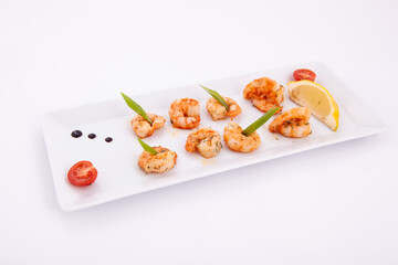 Cooked shrimp served on white plate