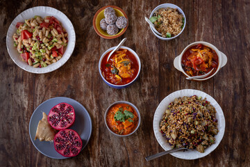 
full table healthy Indian, Asian and Mediterranean dishes with white beans, lentils, sweet potatoes, rice and vegetables