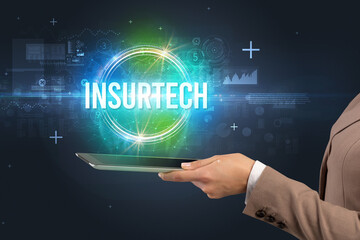 Close-up of a touchscreen with INSURTECH inscription, new technology concept