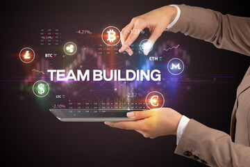 Close-up of a touchscreen with TEAM BUILDING inscription, business opportunity concept
