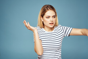 Fototapeta premium Upset woman emotions displeasure gestures with hands blue background