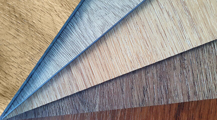 macro view of wooden vinyl floor tile samples. swatch of vinyl wooden flooring material showing multi colore and pattern.