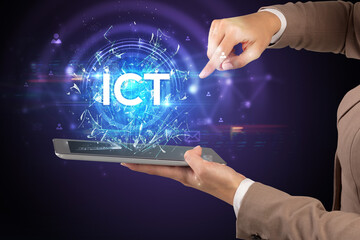 Close-up of a touchscreen with ICT abbreviation, modern technology concept