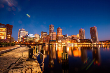 Night view and city lights of Boston skyline by the harbour 