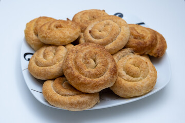 Sweet cinnamon rolls on a white plate