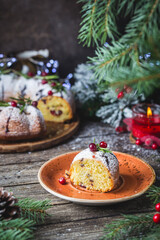 Traditional homemade christmas cake with cranberry and chocolate with new year tree decoration on vintage wooden table background. Rustic style.