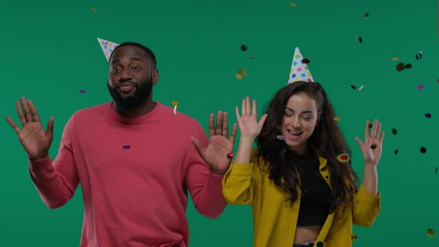 Black Man And White Woman Couple Dancing With Confetti Rain Isolated On Green Screen, Chroma Key