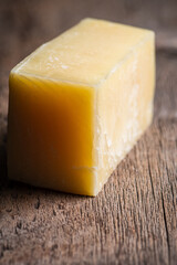 Tasty parmesan cheese on the rustic background. Selective focus. Shallow depth of field. 