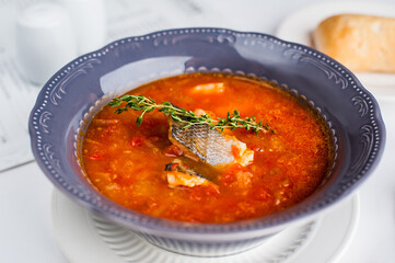 Soup with fish in a blue plate