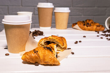 Take Away Coffee with Fresh Croissant With Chocolate and Coffee Beans on wooden background, Copy Space