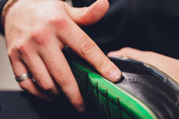 Brushes, wax, boots. applying cream with your finger. Shoe repair.