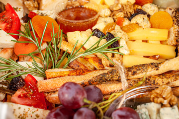 A box of food, cheese, breads, fish, shrimp. Food delivery for the company, romantic, office dinner at home. Beautiful composition of food in a box, convenient carrying, fresh products.