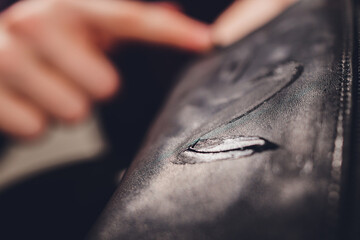 boots. applying cream with your finger. Shoe repair.