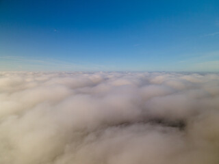 Above the clouds. Flight through the clouds in the morning. Fog, sky, thick clouds.