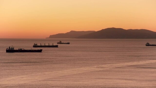 Cargo ships at sea at sunset in summer. Video in HD quality