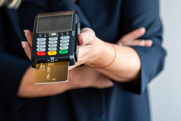 close-up of female hands hold terminal for payment by non-cash money
