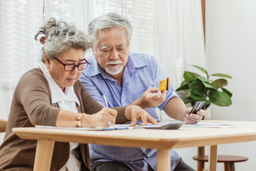 Stressed senior elderly couple conclict of credit card bills or bebt of expense in shopping. Lover financial risk or crisis and bad habits of shopaholic. Lack of money discipline, planning and advisor