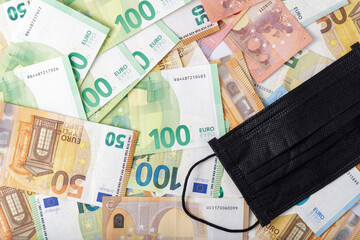 Medical black mask on euro money background. Coronavirus pandemic concept