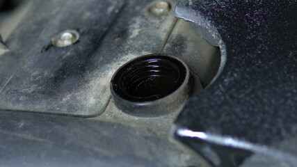Car oil is poured into the neck of the engine