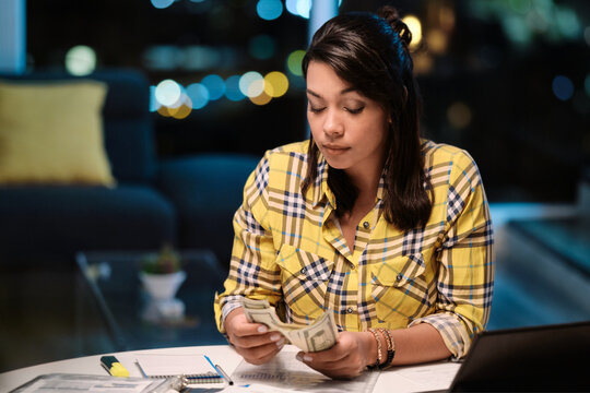 Latin American Woman Doing Home Budget And Counting Money