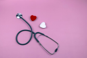 Red and white heart with stethoscope on pink background, heart health, heart diseases, health insurance concept