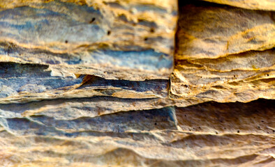 Background - Stacked Stone Wall with Lighting from Above side.uneven stone ribbed surface of sand color. Wall with Lighting from Above side.