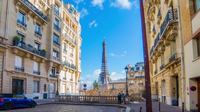 4k timelapse video of the cozy street with view of Eiffel Tower in Paris.Romantic view from a small paris street on a cloudy autumn day in spring summer - wide horizontal panorama