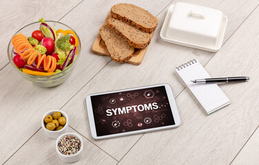 Healthy Tablet Pc compostion with SYMPTOMS inscription, immune system boost concept