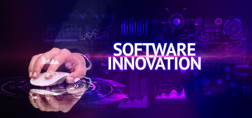 hand holding wireless peripheral with SOFTWARE INNOVATION inscription, modern technology concept