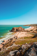 Sea coast with rocks in the water and waves, a delightful panoramic shot on a trip