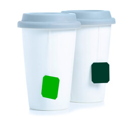 Two cups mugs of tea with lids on white background isolation
