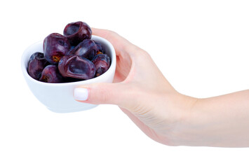 Hand holding dried dates fruit in bowl on white background isolation