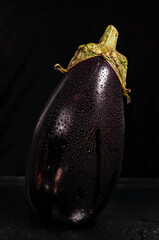 Close up wet eggplant isolated on black background