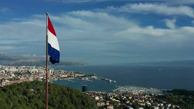 flying counter clockwise around Croatian flag atop Marjan Hill outside Split