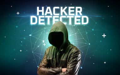 Mysterious hacker with HACKER DETECTED inscription, online attack concept inscription, online security concept