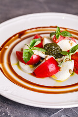 Caprese salad with mozzarella, tomato, basil and pesto