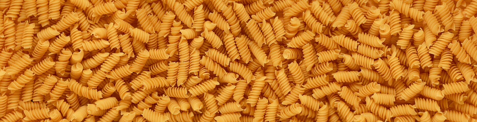Background, dry pasta. Panorama. The view from the top.