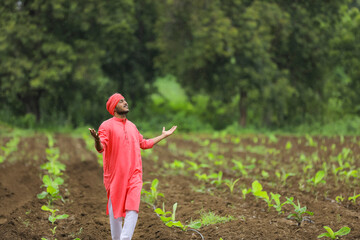Young Indian farmer at banana field