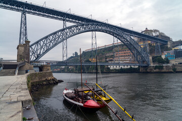 The iron bridge Ponte Dom Luís I over the river Douro with boats in Porto