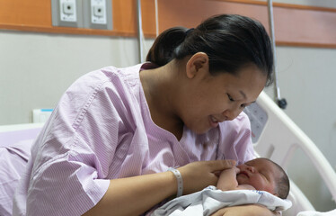 New Born Baby Girl Is Holding onto Mother's Finger