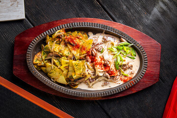 Roasted potatoes with stewed beef in creamy sauce